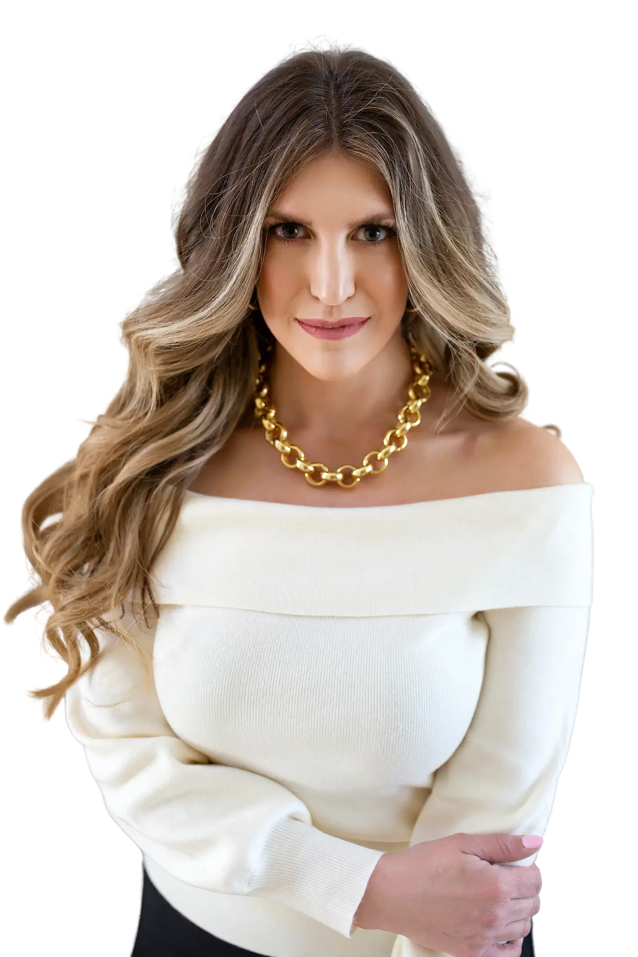 Allie Bjerk in a cream off-the-shoulder sweater and gold necklace